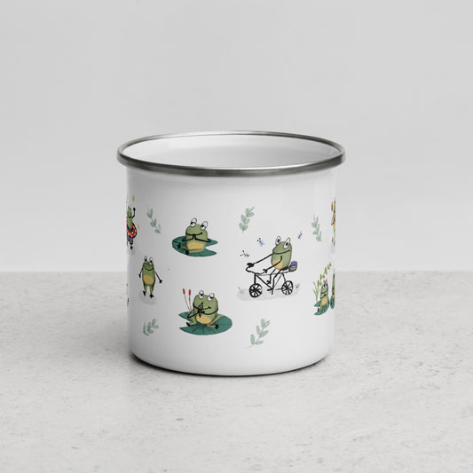 An enamel mug with multiple cute green frogs on it. One frog is rifing a bike and another frog eating an ice cream and another from doing yoga